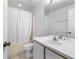 Bathroom features a shower/tub combo with tile flooring, toilet and vanity with large mirror at 2274 Stonehedge Loop, Kissimmee, FL 34743