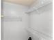Walk-in closet featuring wall-mounted white wire shelving, offering ample storage space at 2274 Stonehedge Loop, Kissimmee, FL 34743