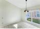 Cozy dining area with tile flooring, a chandelier, and a large window at 2274 Stonehedge Loop, Kissimmee, FL 34743