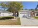 Charming single-story home featuring a well-manicured lawn and a two-car garage at 2274 Stonehedge Loop, Kissimmee, FL 34743