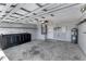 Spacious garage with an unfinished cement floor and storage cabinets at 2274 Stonehedge Loop, Kissimmee, FL 34743