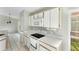 Kitchen featuring white cabinets, a range, and lots of counter space at 2274 Stonehedge Loop, Kissimmee, FL 34743