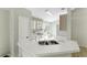 Kitchen featuring white cabinets and appliances and a double sink at 2274 Stonehedge Loop, Kissimmee, FL 34743