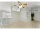 Open-concept living area with tile flooring, neutral walls, and a view of the kitchen bar at 2274 Stonehedge Loop, Kissimmee, FL 34743