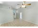 Bright living room with neutral walls, tile floors, and a ceiling fan at 2274 Stonehedge Loop, Kissimmee, FL 34743