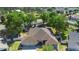 Aerial view of a home showcasing the well-manicured lawn and mature trees at 2301 Angel Fish Loop, Leesburg, FL 34748