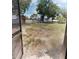 Large backyard featuring a grassy area, privacy fence, and mature trees at 2301 Angel Fish Loop, Leesburg, FL 34748