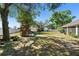 Lush backyard featuring a wooden playset, perfect for outdoor activities at 2301 Angel Fish Loop, Leesburg, FL 34748