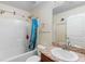 Well-lit bathroom with a shower-tub combo, vibrant decor, and a large mirror at 2301 Angel Fish Loop, Leesburg, FL 34748