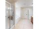 Bathroom with glass shower, soaking tub, tile floors, and white neutral paint and trim at 2301 Angel Fish Loop, Leesburg, FL 34748