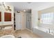 Bathroom featuring a dual vanity, soaking tub, and a separate glass-enclosed shower at 2301 Angel Fish Loop, Leesburg, FL 34748
