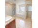 Bathroom with a granite vanity, soaking tub, and shower at 2301 Angel Fish Loop, Leesburg, FL 34748
