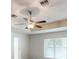 Comfortable bedroom with ceiling fan, light walls and trim, and a large window providing natural light at 2301 Angel Fish Loop, Leesburg, FL 34748