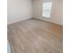 Bright bedroom with laminate wood flooring and natural light from the window at 2301 Angel Fish Loop, Leesburg, FL 34748