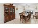 Charming dining room with a wooden hutch, matching dining table, and a sunlit window at 2301 Angel Fish Loop, Leesburg, FL 34748