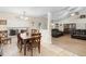 Inviting dining area featuring a wooden table set and tile flooring, adjacent to a cozy living space at 2301 Angel Fish Loop, Leesburg, FL 34748