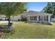 Charming single-story home featuring a well-manicured lawn and a two car garage at 2301 Angel Fish Loop, Leesburg, FL 34748