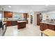 Spacious kitchen with granite countertops, island, tile floors, and dark wood cabinetry at 2301 Angel Fish Loop, Leesburg, FL 34748