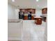 Spacious kitchen with tile floors, wooden cabinets, granite countertops, and stainless steel appliances at 2301 Angel Fish Loop, Leesburg, FL 34748