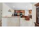 Spacious kitchen with granite countertops, island, tile floors, and dark wood cabinetry at 2301 Angel Fish Loop, Leesburg, FL 34748