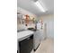 Organized laundry room with modern washer and dryer, shelving, and ample storage at 2301 Angel Fish Loop, Leesburg, FL 34748
