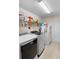 Organized laundry room with modern washer and dryer, shelving, and ample storage at 2301 Angel Fish Loop, Leesburg, FL 34748