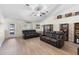 Bright living room with wood flooring, comfortable leather couches, and natural light at 2301 Angel Fish Loop, Leesburg, FL 34748