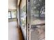 View of backyard through screened porch with black aluminum framing at 2301 Angel Fish Loop, Leesburg, FL 34748