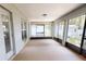 Enclosed sunroom with large windows, tile flooring, and access to the outdoors at 2301 Angel Fish Loop, Leesburg, FL 34748