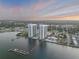 Expansive aerial view of the condo buildings and surrounding area, including water access and docking at 241 Riverside Dr # 601, Daytona Beach, FL 32117