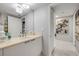 Bathroom with modern fixtures, vanity with stone countertop, and a decorative mirror at 241 Riverside Dr # 601, Daytona Beach, FL 32117
