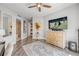 Bright bedroom with a ceiling fan, modern decor, and a peek into the ensuite bathroom at 241 Riverside Dr # 601, Daytona Beach, FL 32117