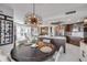 Cozy dining area adjacent to kitchen, featuring a modern chandelier and access to balcony with views at 241 Riverside Dr # 601, Daytona Beach, FL 32117