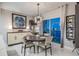 The dining room features modern chandelier, accent wall art and wine rack at 241 Riverside Dr # 601, Daytona Beach, FL 32117