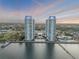 Scenic aerial view of the condo towers, showcasing the in-ground pool, water access, and waterfront boardwalk at 241 Riverside Dr # 601, Daytona Beach, FL 32117