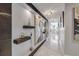 Long hallway featuring designer lighting, built in shelving, marble floors and an open concept to living space at 241 Riverside Dr # 601, Daytona Beach, FL 32117