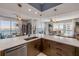 Modern open kitchen featuring an island, sleek countertops, and a view of the waterfront and dining area at 241 Riverside Dr # 601, Daytona Beach, FL 32117