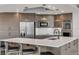 Modern kitchen with stainless steel appliances, dark wood cabinets, bar seating, and marble countertops at 241 Riverside Dr # 601, Daytona Beach, FL 32117