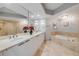 The main bathroom features double sinks, a jetted tub, and a glass enclosed shower at 241 Riverside Dr # 601, Daytona Beach, FL 32117