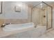 The main bathroom features a large jetted tub and a glass enclosed shower at 241 Riverside Dr # 601, Daytona Beach, FL 32117