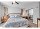 Spacious bedroom featuring soft bedding, hardwood floors, and sliding mirror closet at 241 Riverside Dr # 601, Daytona Beach, FL 32117
