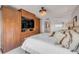 This main bedroom features a closet, elegant lighting, and custom built-in storage and entertainment unit at 241 Riverside Dr # 601, Daytona Beach, FL 32117