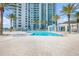 Lovely outdoor pool with poolside lounge chairs and the condo building rising above it at 241 Riverside Dr # 601, Daytona Beach, FL 32117