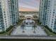 Exterior shot of in-ground pool with lounge chairs and palm trees nestled between two waterfront condo buildings at 241 Riverside Dr # 601, Daytona Beach, FL 32117