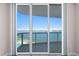 This balcony features floor to ceiling sliding glass doors and views of the pool and water at 241 Riverside Dr # 704, Holly Hill, FL 32117