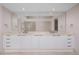 A modern bathroom featuring dual sinks with a large mirror, and glass shower at 241 Riverside Dr # 704, Holly Hill, FL 32117