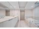 A Primary bathroom includes dual sinks, large mirror, soaking tub, and glass shower at 241 Riverside Dr # 704, Holly Hill, FL 32117