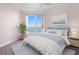 Comfortable bedroom featuring a waterfront view from a large window providing an abundance of natural light at 241 Riverside Dr # 704, Holly Hill, FL 32117