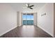 This bedroom features tile flooring, a ceiling fan, and floor to ceiling windows at 241 Riverside Dr # 704, Holly Hill, FL 32117