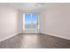 Bright bedroom with tile flooring and a large window providing an abundance of natural light at 241 Riverside Dr # 704, Holly Hill, FL 32117